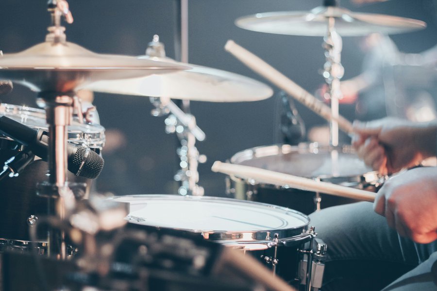 Drummer playing drum kit